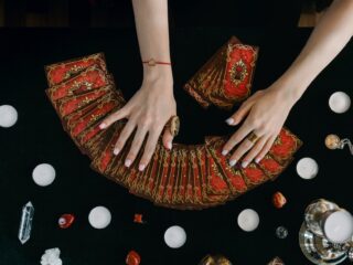 Photo by Mikhail Nilov on <a href="https://www.pexels.com/photo/a-person-holding-tarot-cards-6944923/" rel="nofollow">Pexels.com</a>