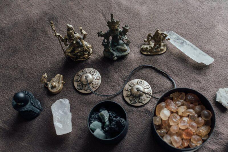brass figurines and crystals used in a ritual