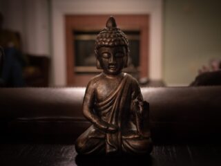 Photo by Sunilkumar Krishnamoorthy on <a href="https://www.pexels.com/photo/brass-buddha-figurine-on-black-surface-1585716/" rel="nofollow">Pexels.com</a>